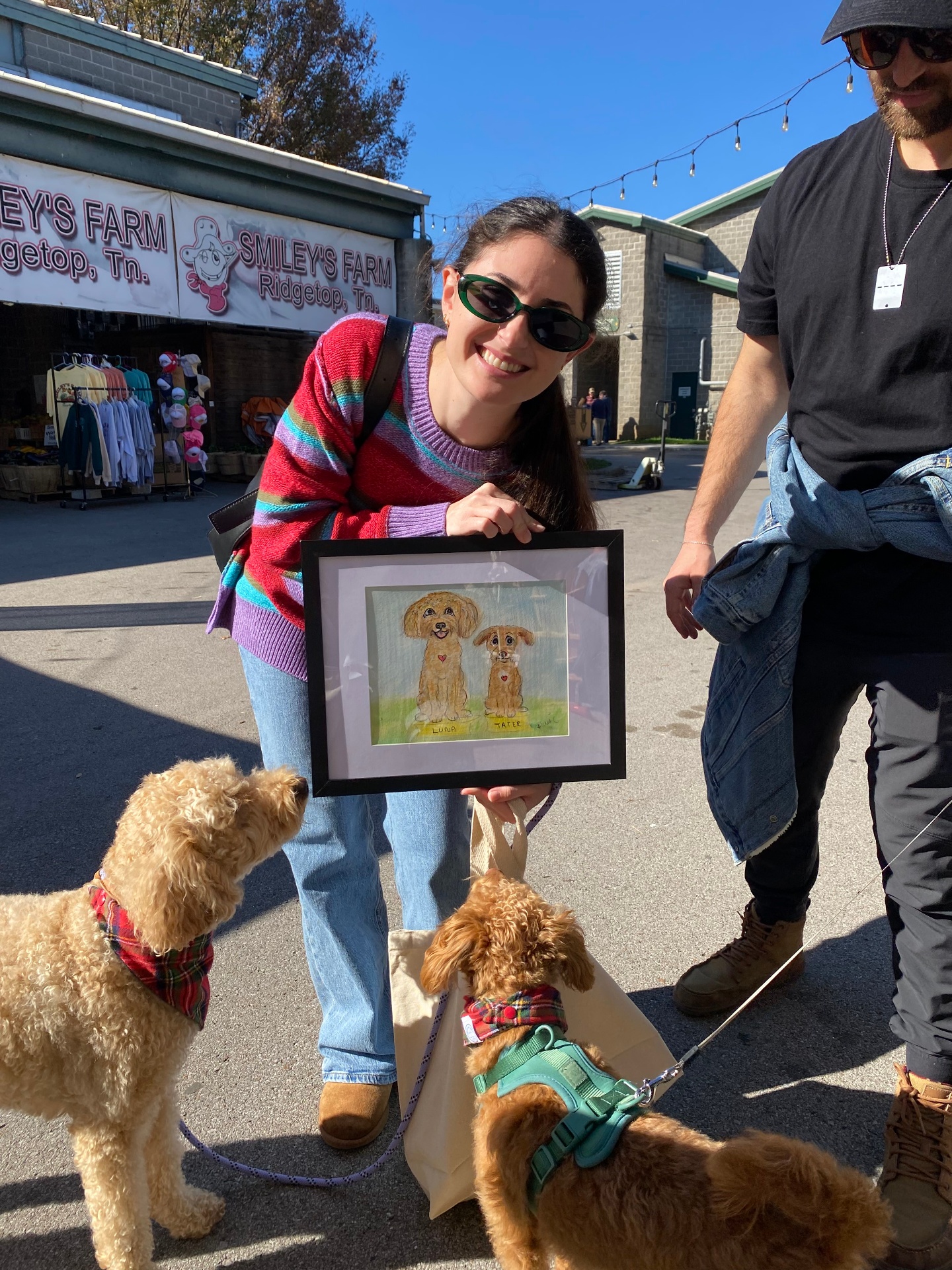 Ally outdoors with two doodles and a custom pet portrait